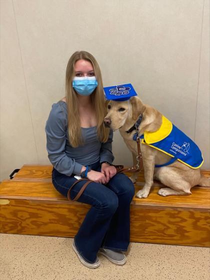 A student with the service dog in training.