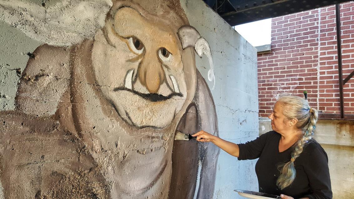 Audrey Sullivan painting Troll Mural