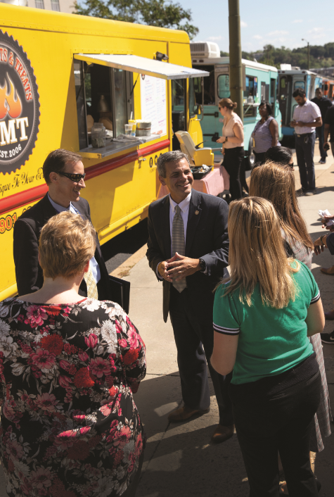 Food trucks come to Capitol Square during lunchtime each week as part of Gov. Ralph Northam’s OnTheSquareVA initiative, which promotes activities for state employees in the area. Damico (center) oversees the program.