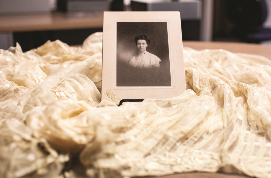A photo of Mary Venable Cox Mattoon, Class of 1900, is surrounded by her wedding dress. Both items are in the Greenwood Library archives. The photography of Mattoon’s great-great-granddaughter, Eva O’Leary, is currently on exhibit at the Longwood Center for the Visual Arts.