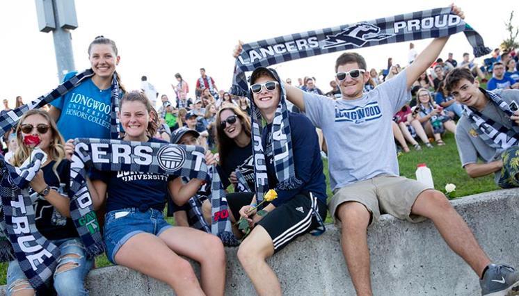 Longwood students proudly holding up their new scarves at The G.A.M.E.