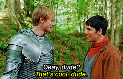 GIF of a man in armor talking to a man in plain clothes