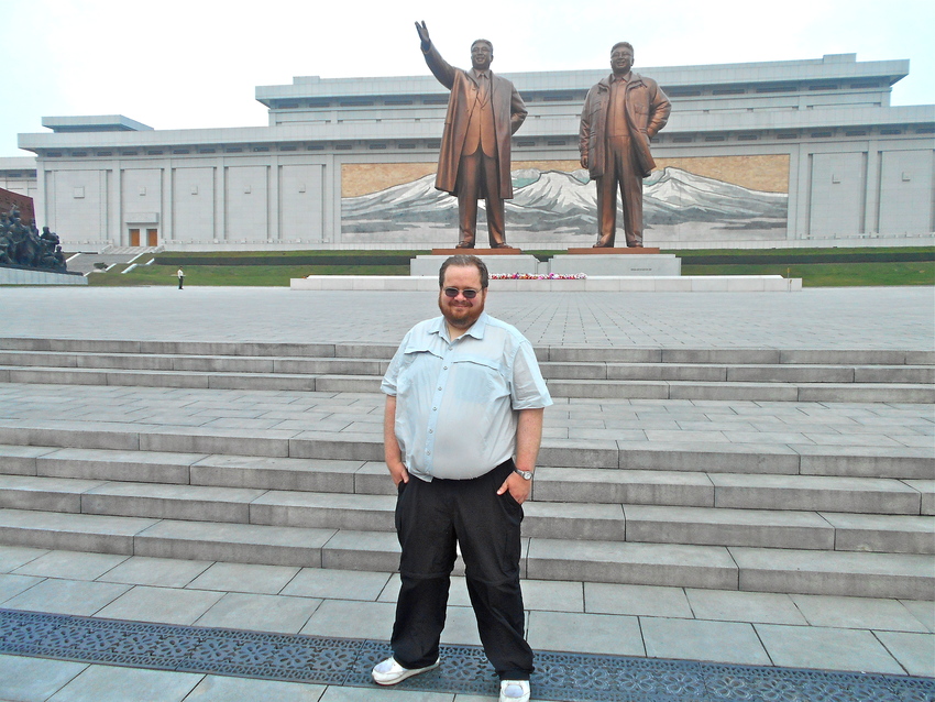 Bradley Boswell in front of Pyongyang's Mansu Hill Grand Monument, with its statues of North Korea's first two leaders.