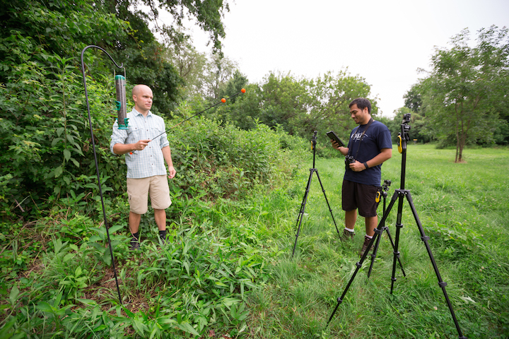 Dr. Brandon Jackson (left) and Alexon Munson-Catt ’16 calibrate the videography equipment they used to track wild birds’ flight patterns and energy use while foraging.