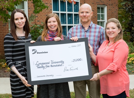 Katharine Bond '98, presents $25,000 from the Dominion Foundation to professors Dr. Dina Leech (from left), Dr. Mark Fink and Dr. Kathy Gee for the university's LEO project.