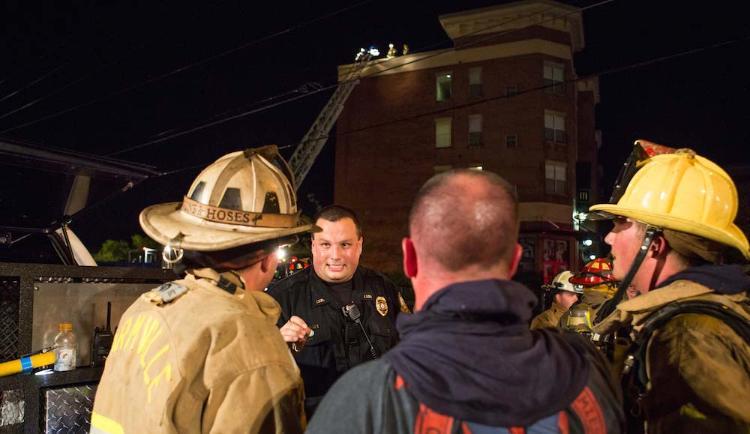 LUPD Sgt. Walter Whitt, who was the first to smell smoke in the Landings building and helped evacuate the building, talks with fire crews the night of the fire.