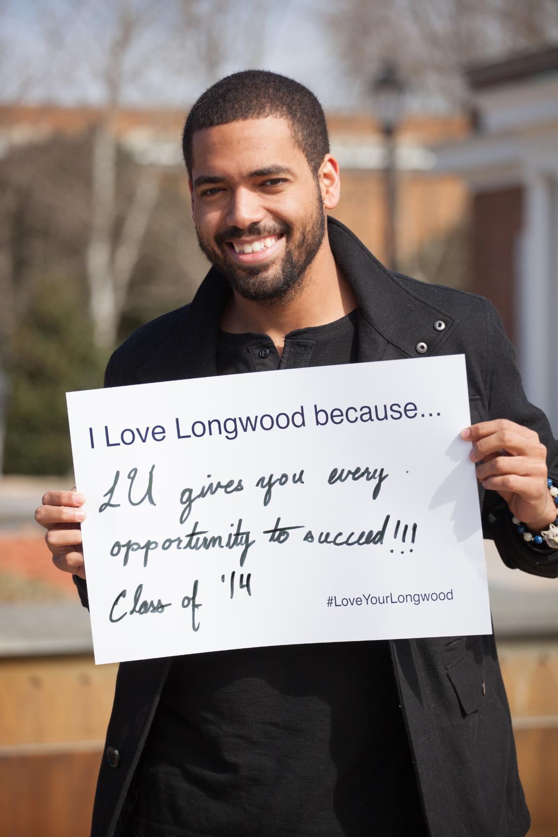 Student holds Love Your Longwood sign