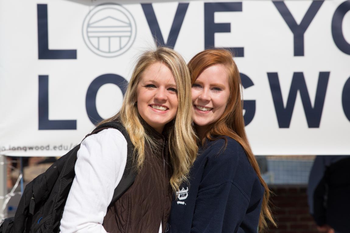 Students pose in front of Love Your Longwood sign