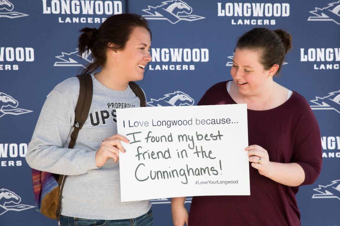 Students hold Love Your Longwood sign