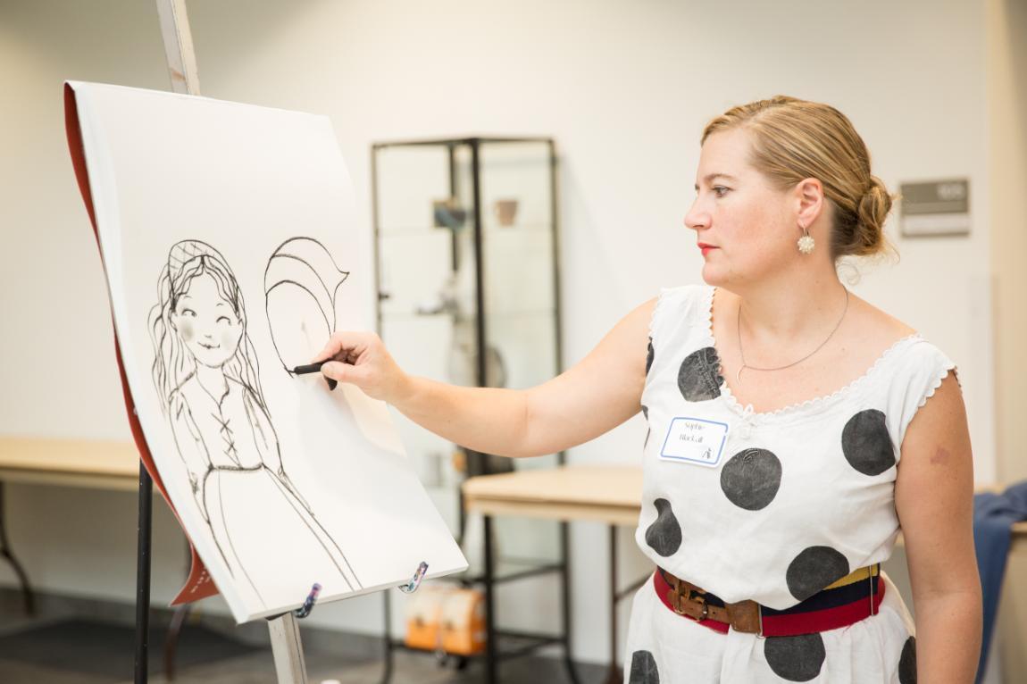 Illustrator Sophie Blackall draws during a presentation to school groups at the 2015 Virginia Children’s Book Festival. Blackall won the 2016 Caldecott Medal for illustrations in the book Finding Winnie