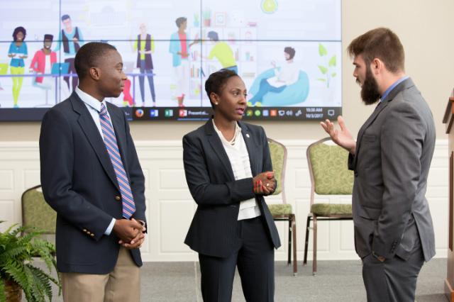 Longwood junior Joseph Hyman speaks with Traci DeShazor, deputy secretary of the commonwealth, and Praise Nyambiya after a roundtable discussion on boosting millennial civic engagement hosted by Longwood last fall.