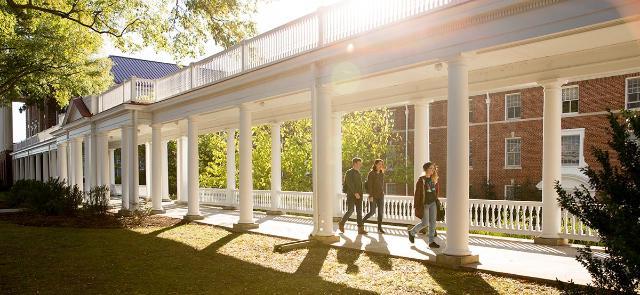 Students walking through colonnades on Longwood's campus