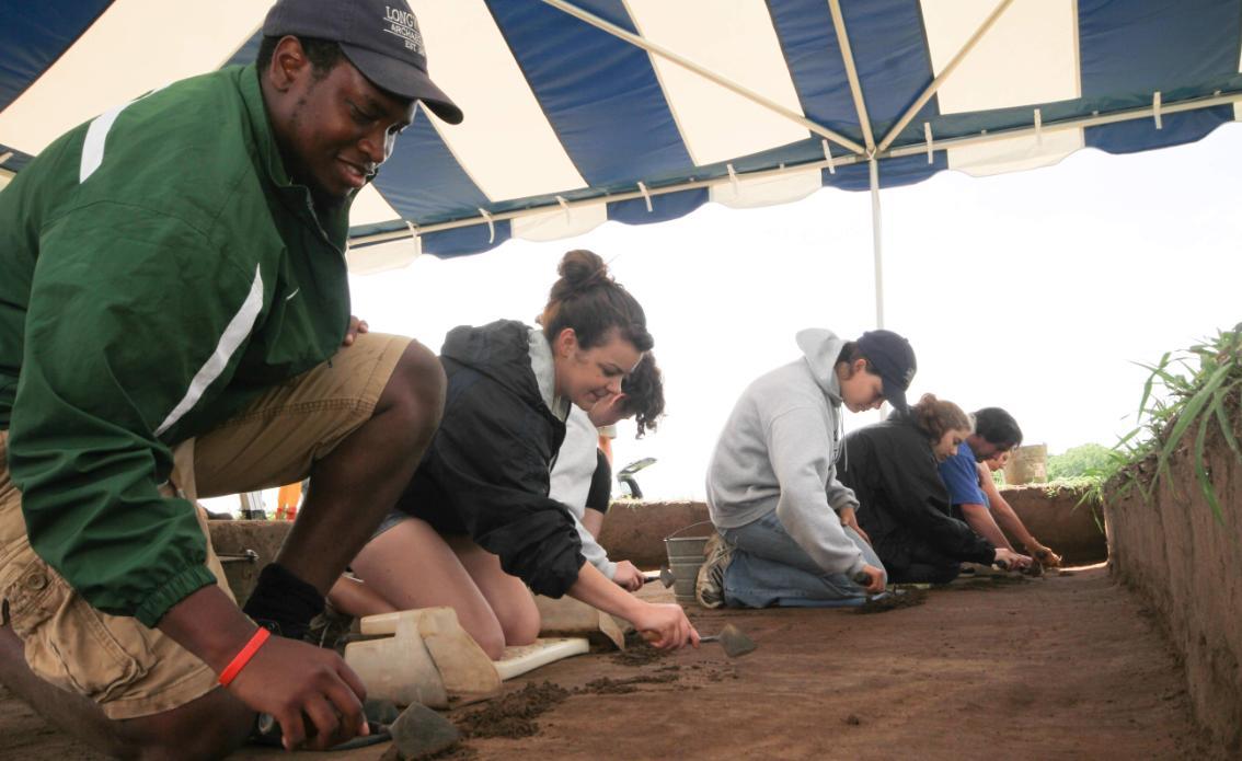 Students participating in a dig at the Archaeology Field School