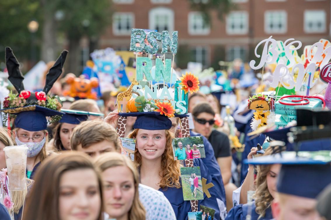 As part of a longstanding Longwood tradition, the gravity-defying caps are decorated by friends to reflect the recipient's personality and passions.