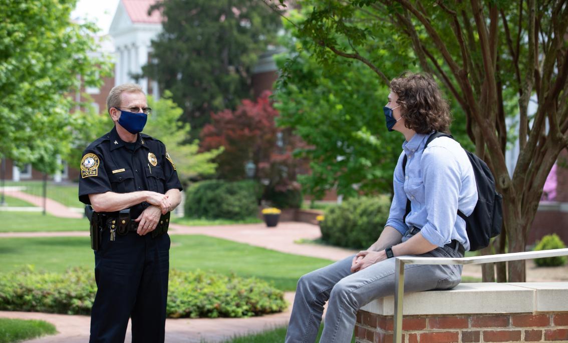 Chief Doug Mooney ‘86 talks with a student on campus