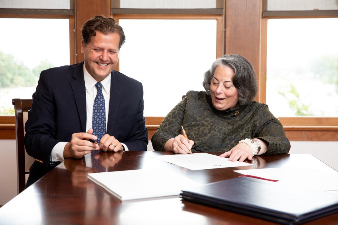 Longwood Rector Pia Trigiani signs a resolution to name Longwood's historic property on the Northen Neck as the The Gerald L. Baliles Center for Environmental Education at Hull Springs.