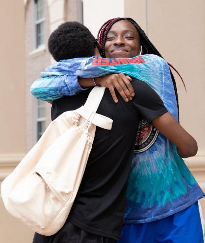 Sister hugs her brother during freshman move-in