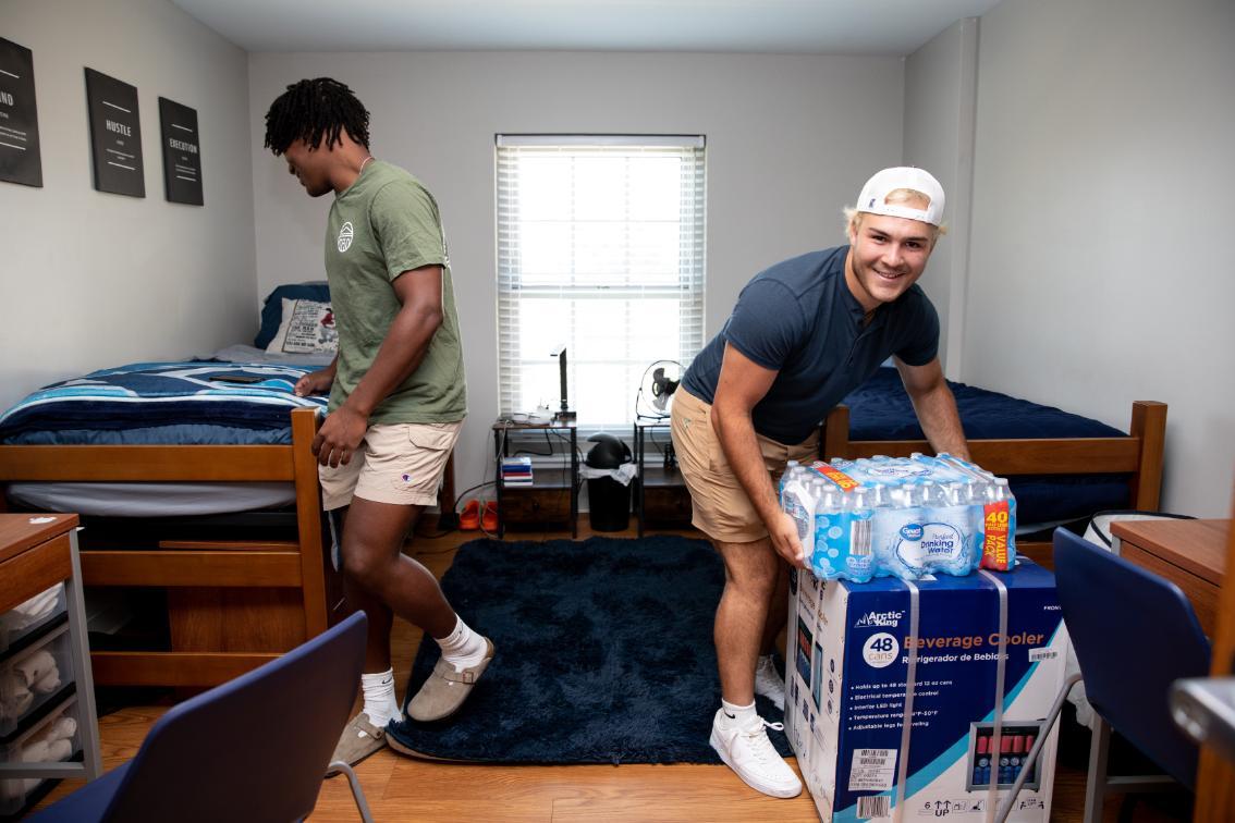 Students arranging their room on move in day