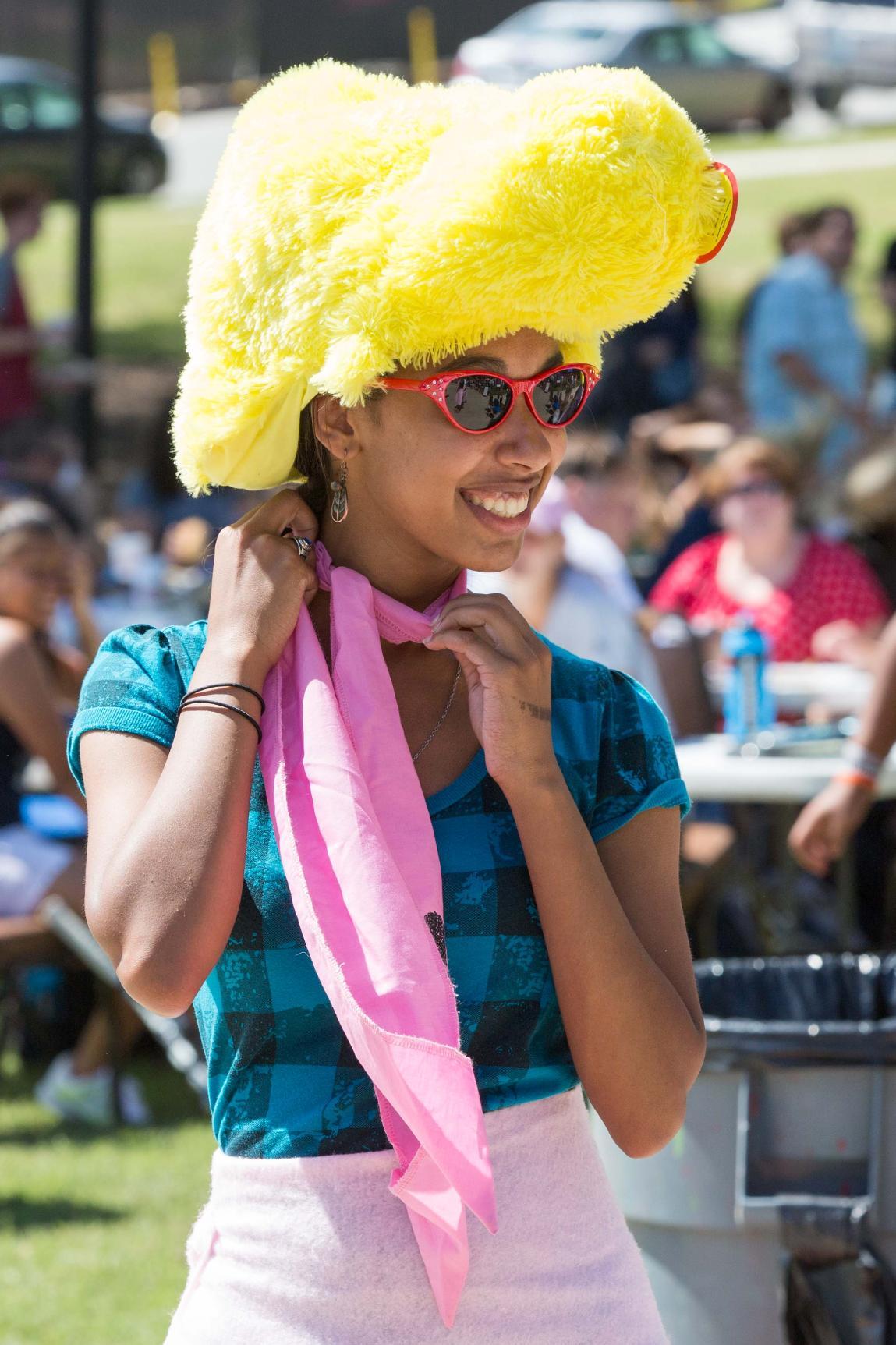 A young woman in a wig and a scarf at Longwood's Family Weekend