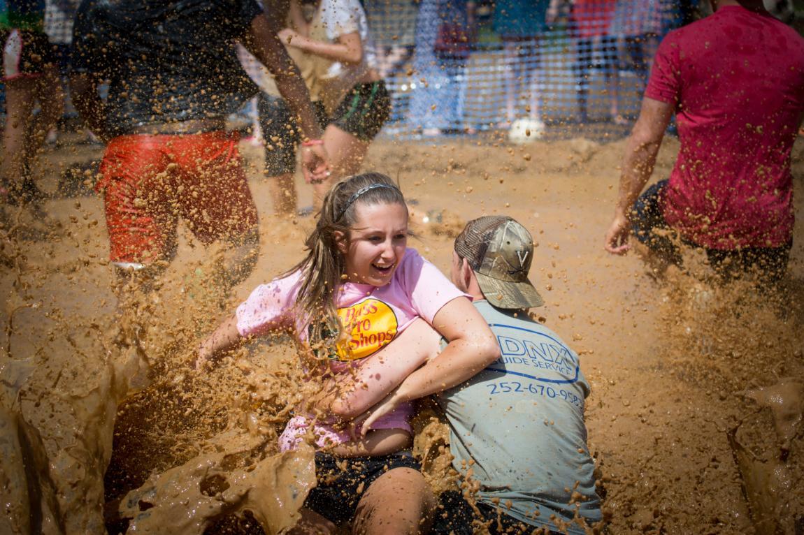 Students play in the mud after Oozeball at Longwood's Spring Weekend
