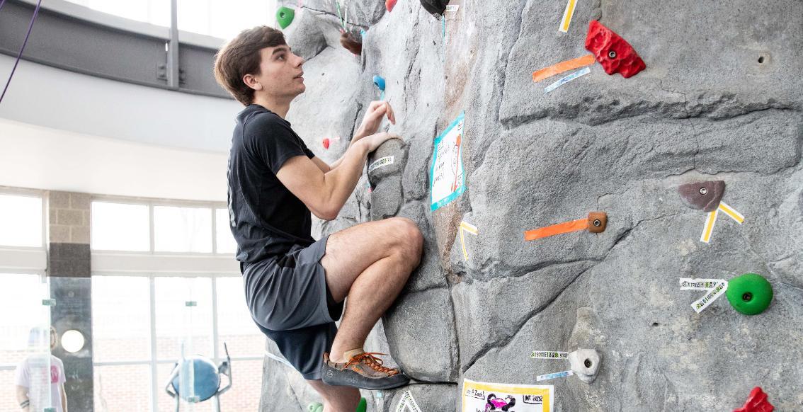 Person on the climbing wall at the Center for Health and Fitness