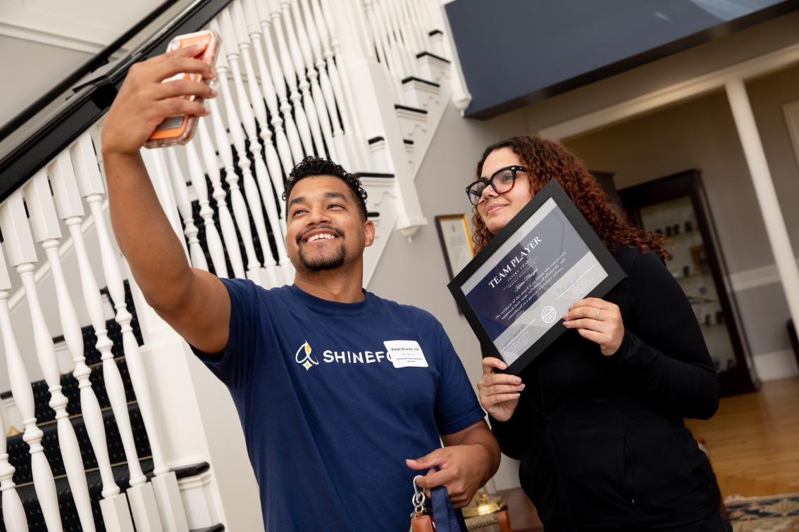 Longwood internship award recipient poses for a photo with a Career Success representative.