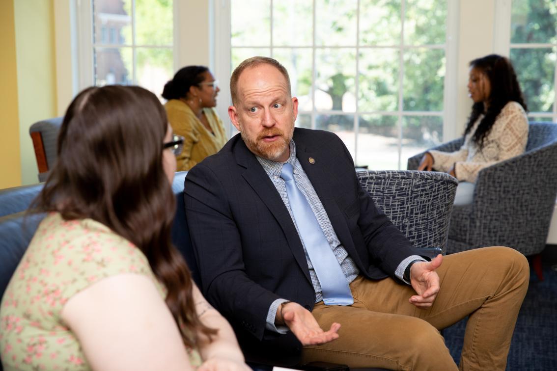 Two mentors and their students chatting one-on-one