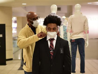 A CLASP student gets fitted for a suit during the JCPenny suit up event.