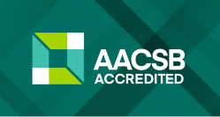 AACSB Accredited - AACSB Accredited logo featuring a geometric green and white design on a dark teal patterned background, with the text “AACSB Accredited” in bold white letters.