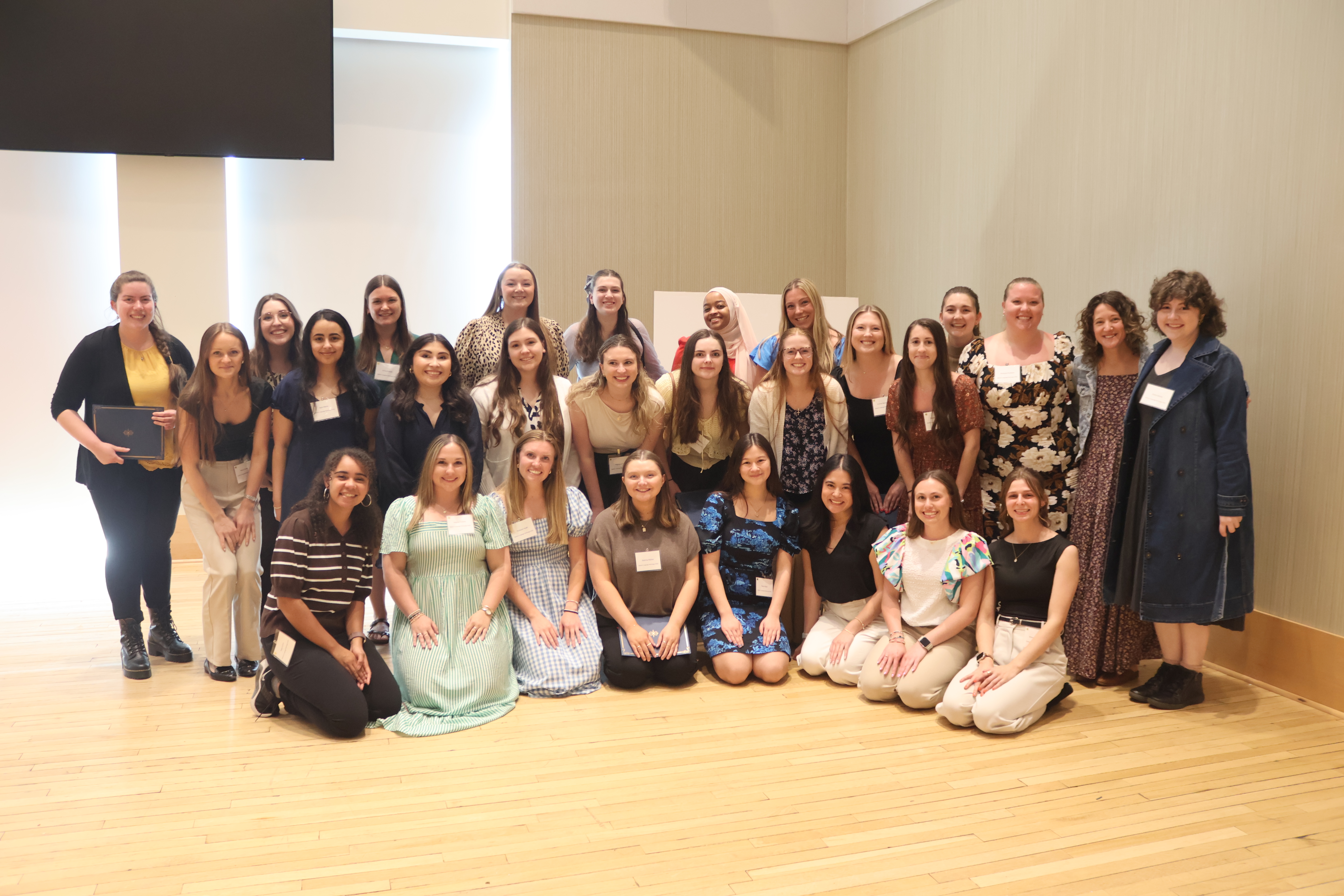 - Longwood graduate students and faculty pose together at a research symposium.