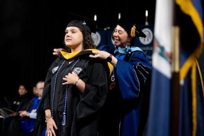 Graduate being hooded at the 2025 Graduate Commencement Ceremony