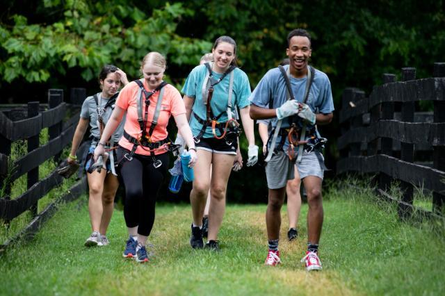 Students walkk with harnesses to the ropes course during the 2021 leadership retreat