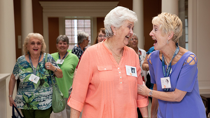 Two alums laughing with each other