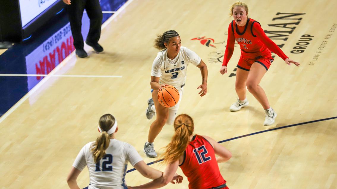 Longwood women’s basketball player drives toward the basket during a game in the Joan Perry Brock Center.