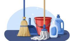 Group of cleaning supplies including a broom, mop, bucket, dustpan, and bottles arranged on a blue background.
