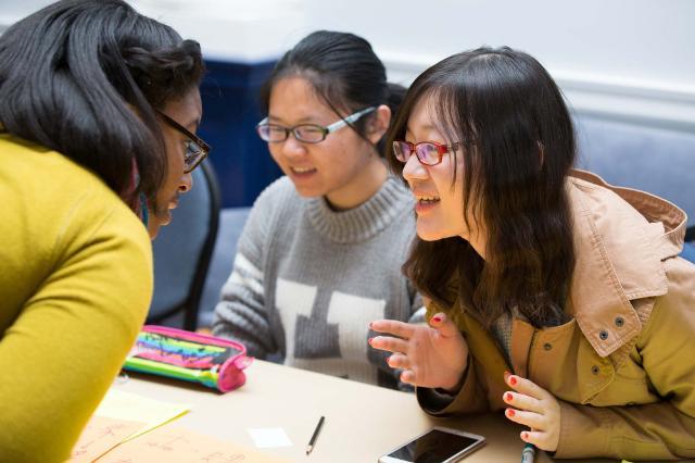 Chinese students talking at a table