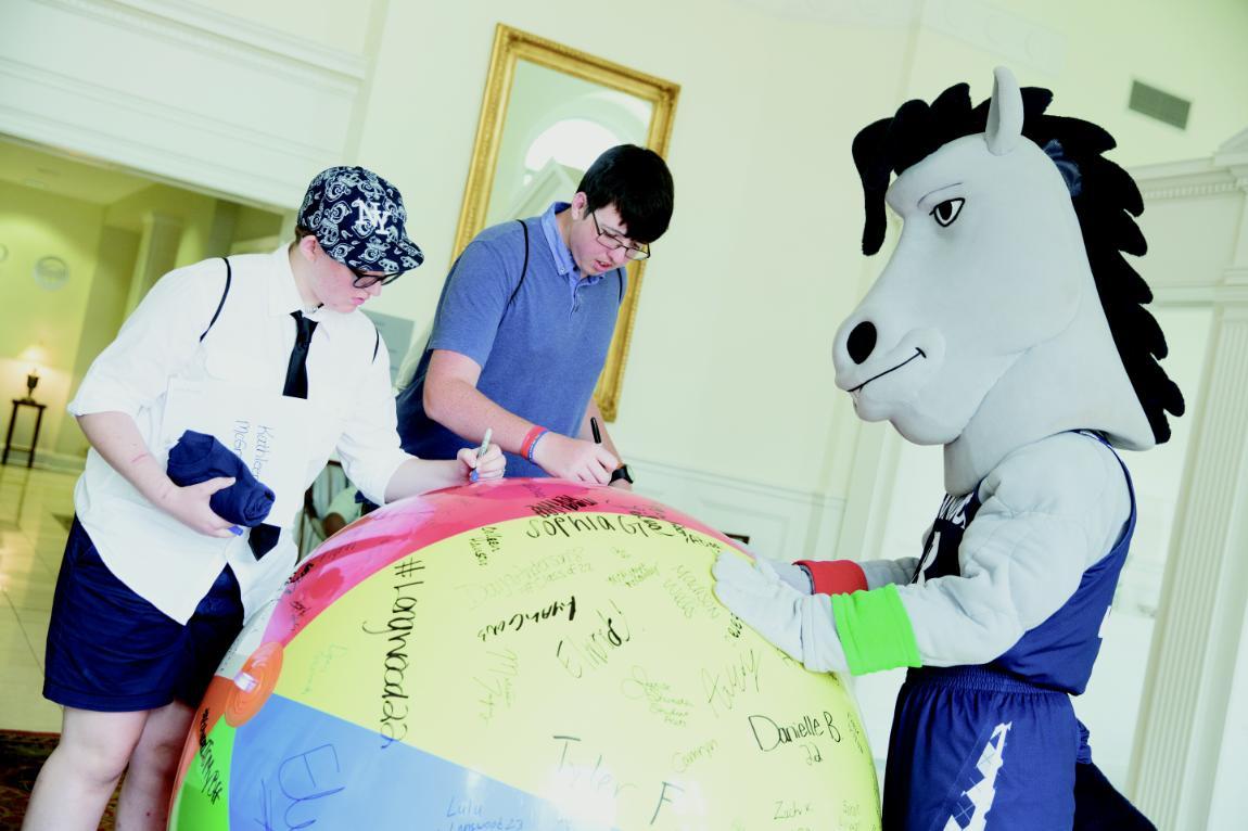 Newly admitted Lancers signed their names on a beach ball. 