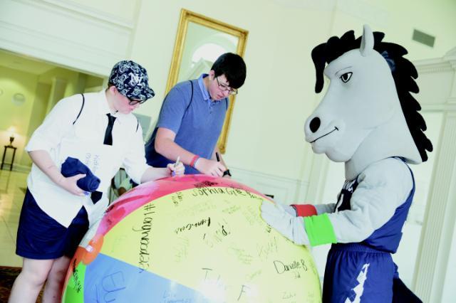 Newly admitted Lancers signed their names on a beach ball. 