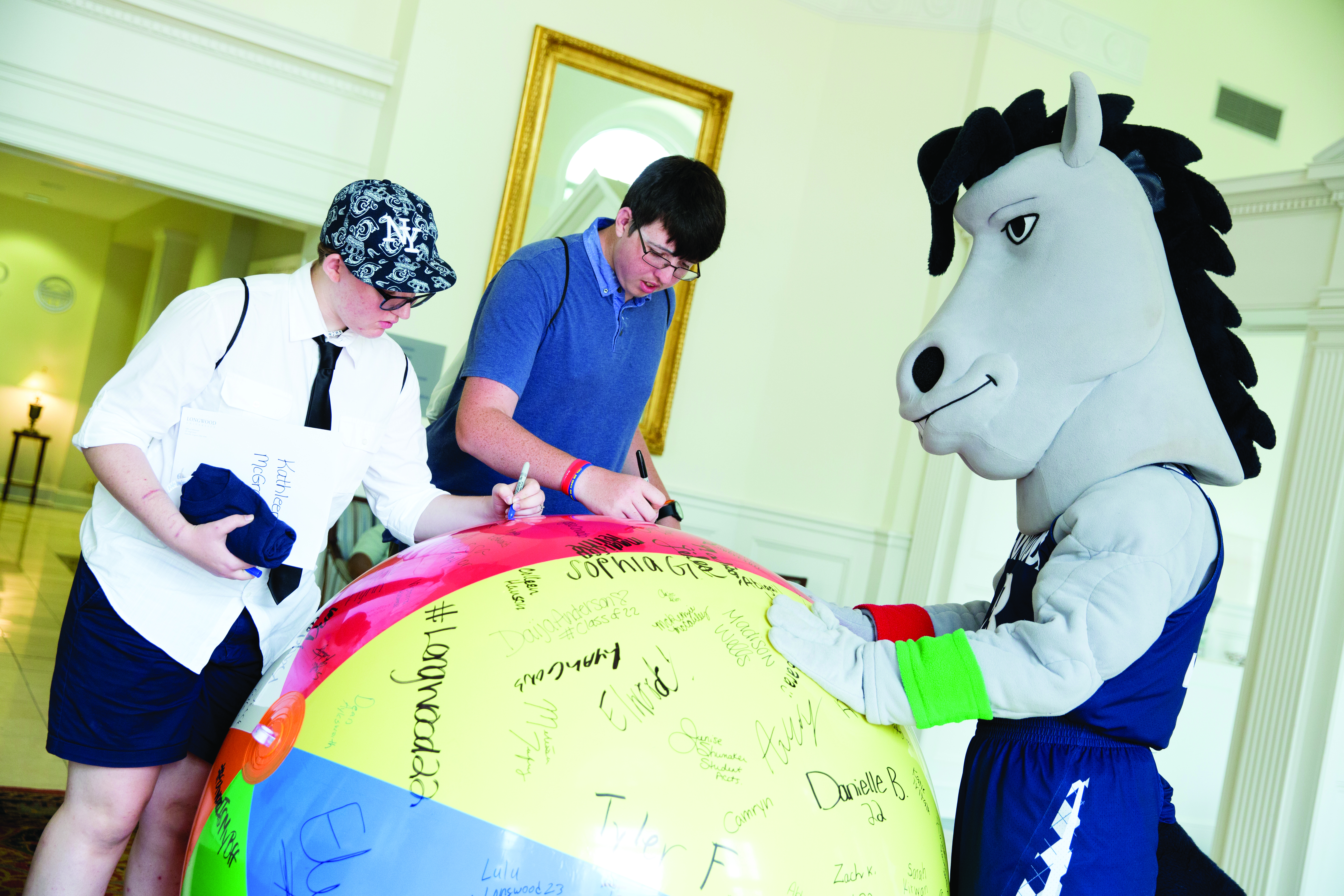 Newly admitted Lancers signed their names on a beach ball. 