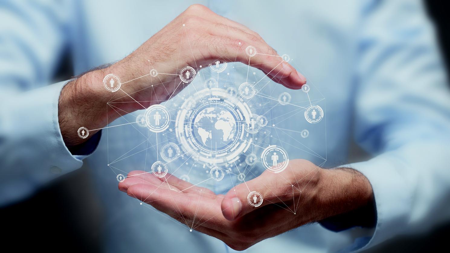 Hand holding a graphic of the world with people and connections