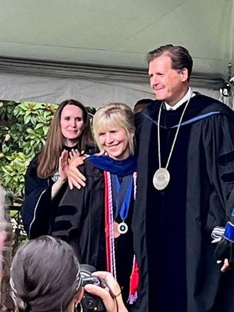 Dr. Little and LU President, Taylor Reveley side hug on stage at the 2022 Commencement.