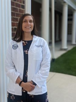 Photo of Sarah anderson in a white lab coat.
