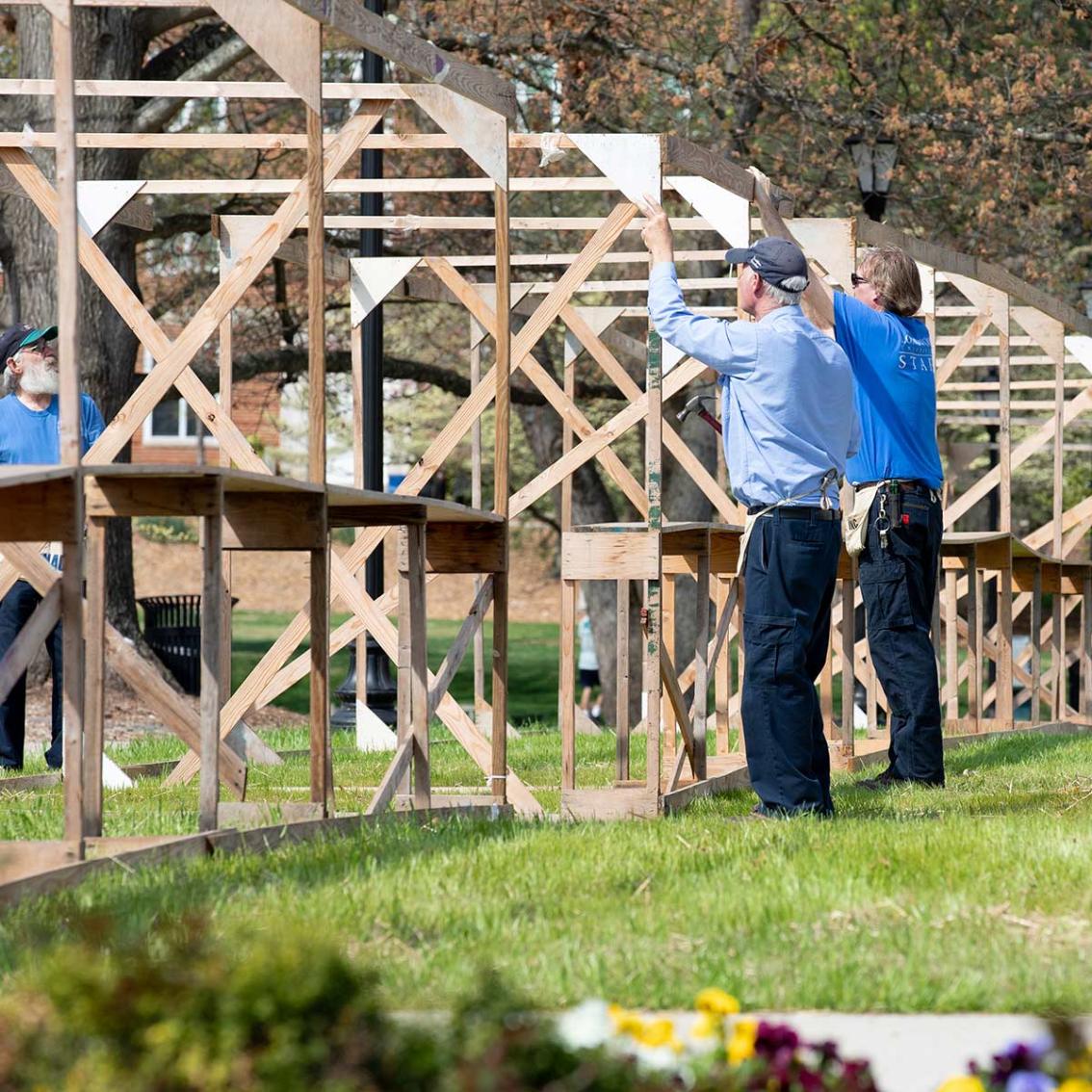 Facilities staff construct the famous booths for clubs and organizations that is one of the highlights of Spring Weekend. Thousands of students will pass by these structures in the next two days, picking up swag and celebrating life at Longwood.