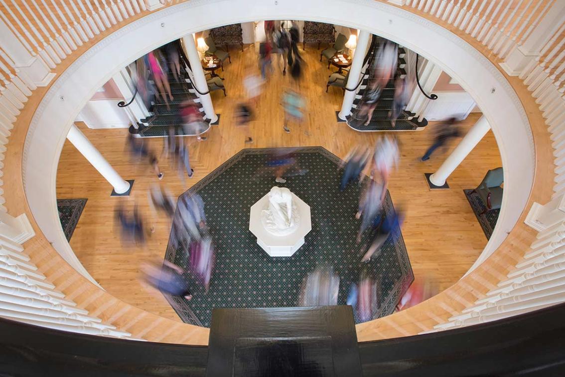 Class change. The original face of Joan of Arc on campus—affectionately known as “Joanie on the Stony”—stays silently watchful in the front lobby of the Rotunda as students make their way to the next class of the day.