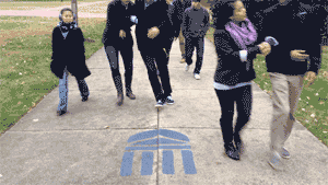 Students avoiding stepping on a blue Rotunda