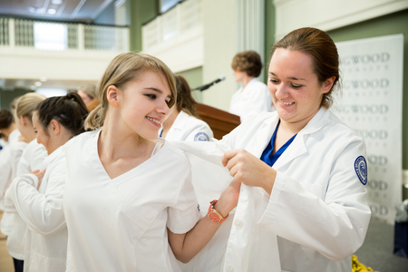 The white coat marks the transition into clinical practice.
