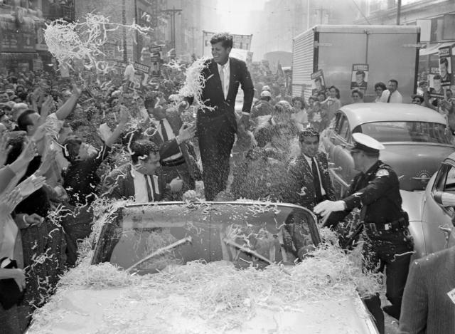 Sen. John F. Kennedy is deluged with confetti and paper streamers as his car moves slowly up Broadway in downtown Los Angeles, Nov. 1, 1960. The Democratic presidential nominee got a wild welcome as he began a final quest for California's 32 electoral votes. (AP Photo/Dick Strobel)