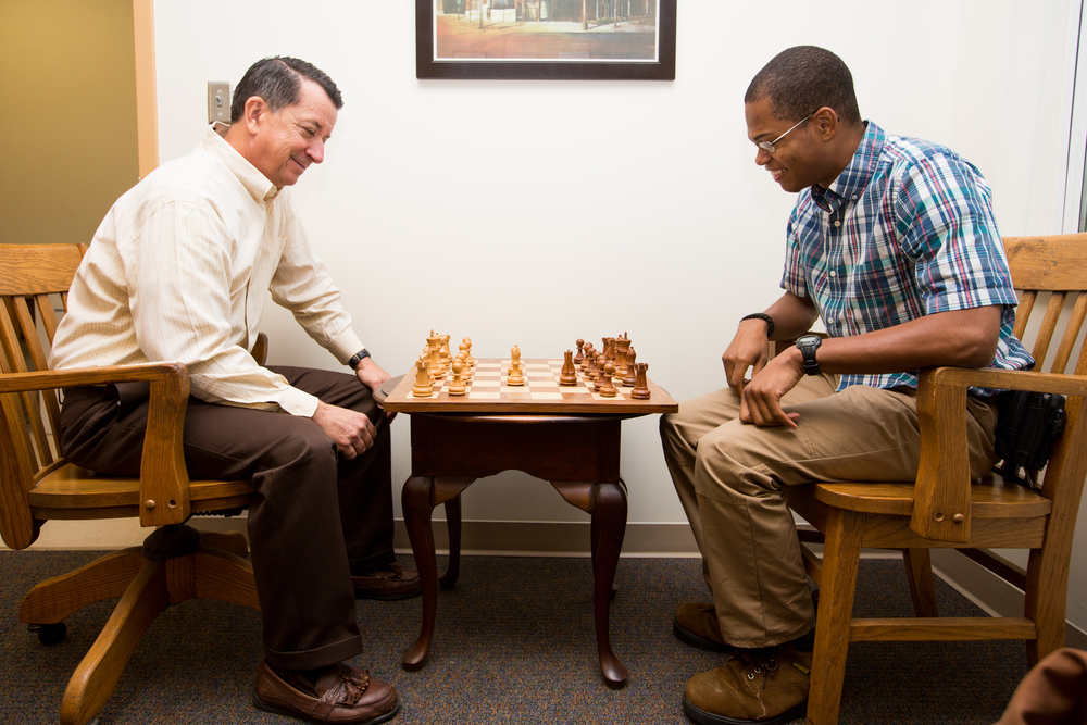 Physics professor and former Cook-Cole College of Arts & Sciences Dean Chuck Ross considers an opening move against senior history major Alex Morton