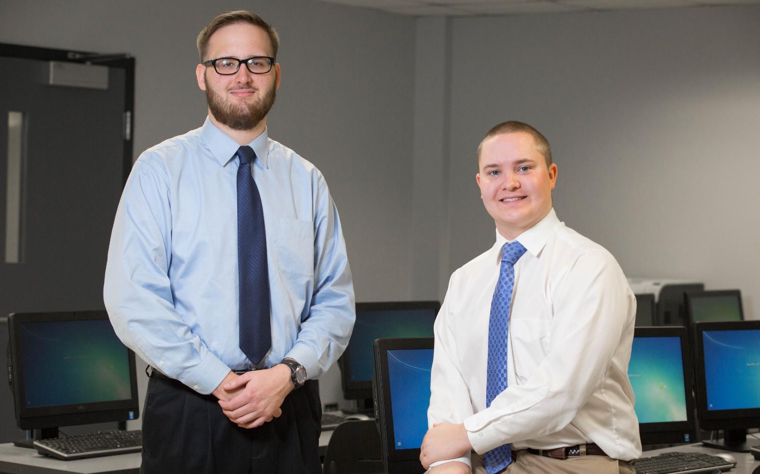 Cyber security scholarships that Tyler Chuba ’18 (left) and Michael Moore ’18 recently received from the state will aid their career plans.