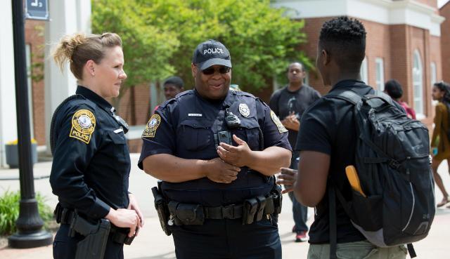 LUPD officers Rachel Whitehead and Quincy Steele chat with senior biology major Samuel McClain on Brock Commons. Officers stand out on Brock Commons most days at 1:45 p.m. to chat and get to know students.